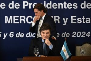 Uruguay's President Luis Lacalle Pou walks behind Argentina's President Javier Milei during the LXV Mercosur Summit in Montevideo on December 6, 2024. Mercosur and the European Union have concluded "negotiations for a free trade agreement," European Commission President Ursula von der Leyen announced in Montevideo on December 6. (Photo by Eitan ABRAMOVICH / AFP)