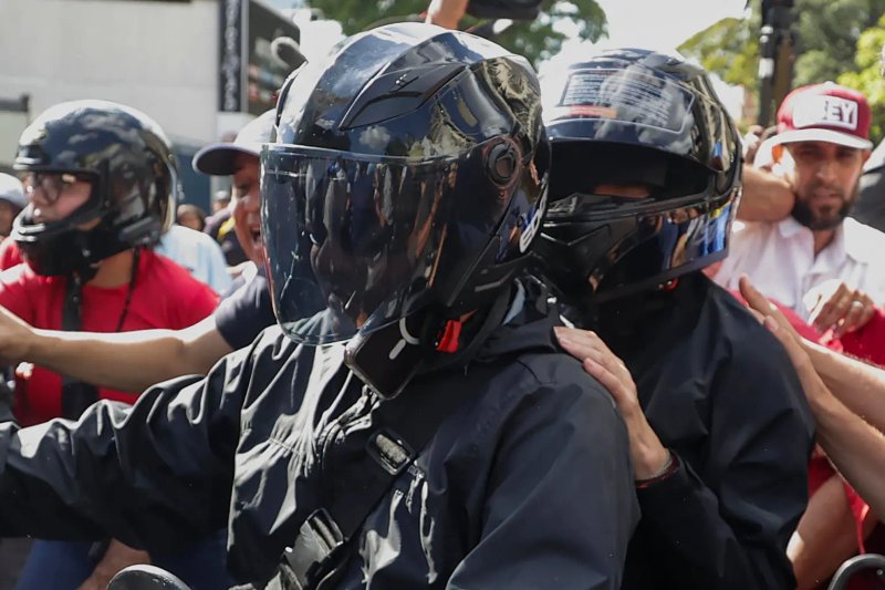 La líder antichavista María Corina Machado (de casco negro) se retira de una manifestación este jueves, en Caracas (Venezuela). Foto La Hora: EFE